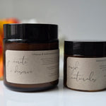 Two jars with labels on a white surface with a blurred background