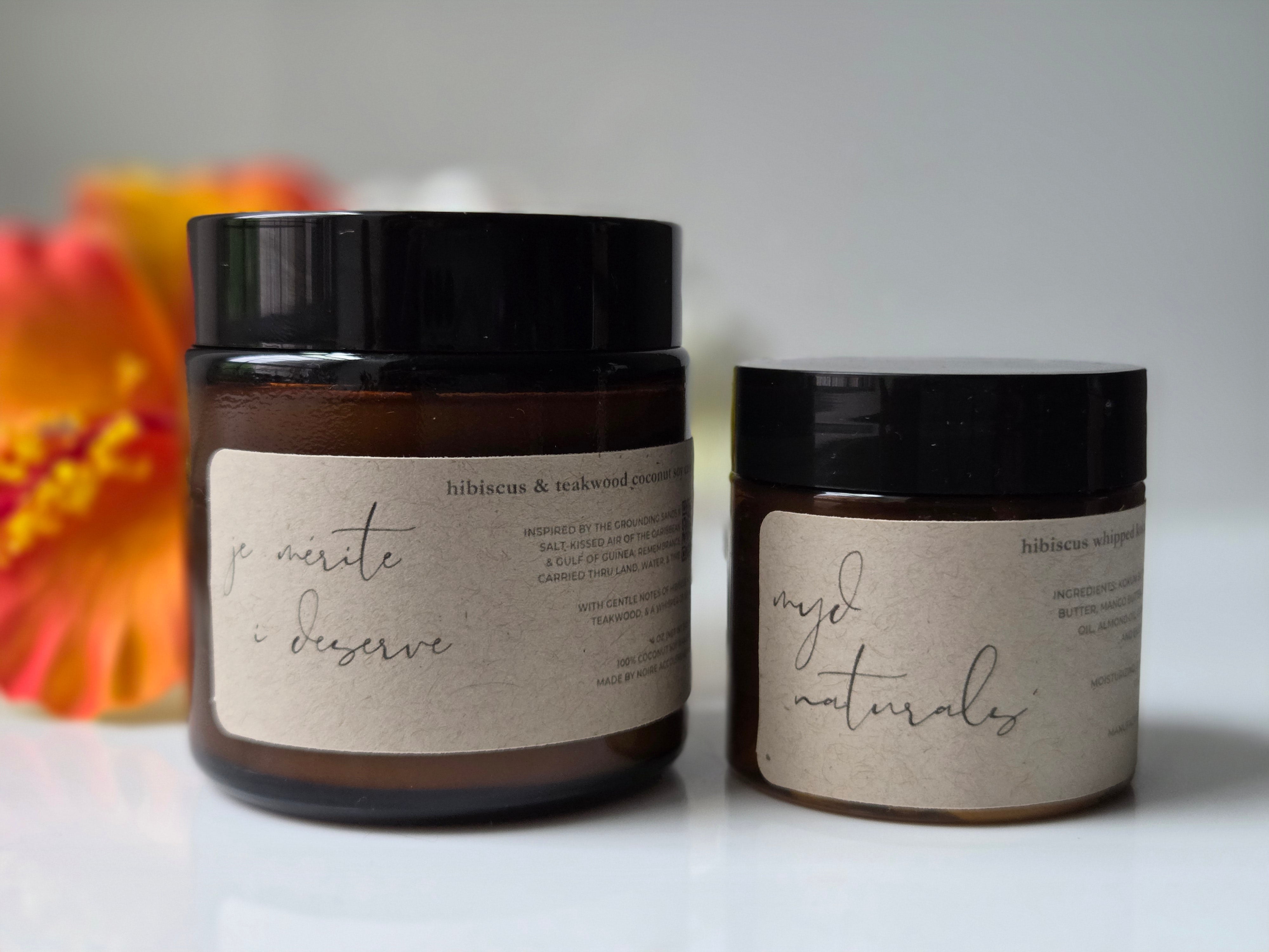 Two jars with labels on a white surface with a blurred background