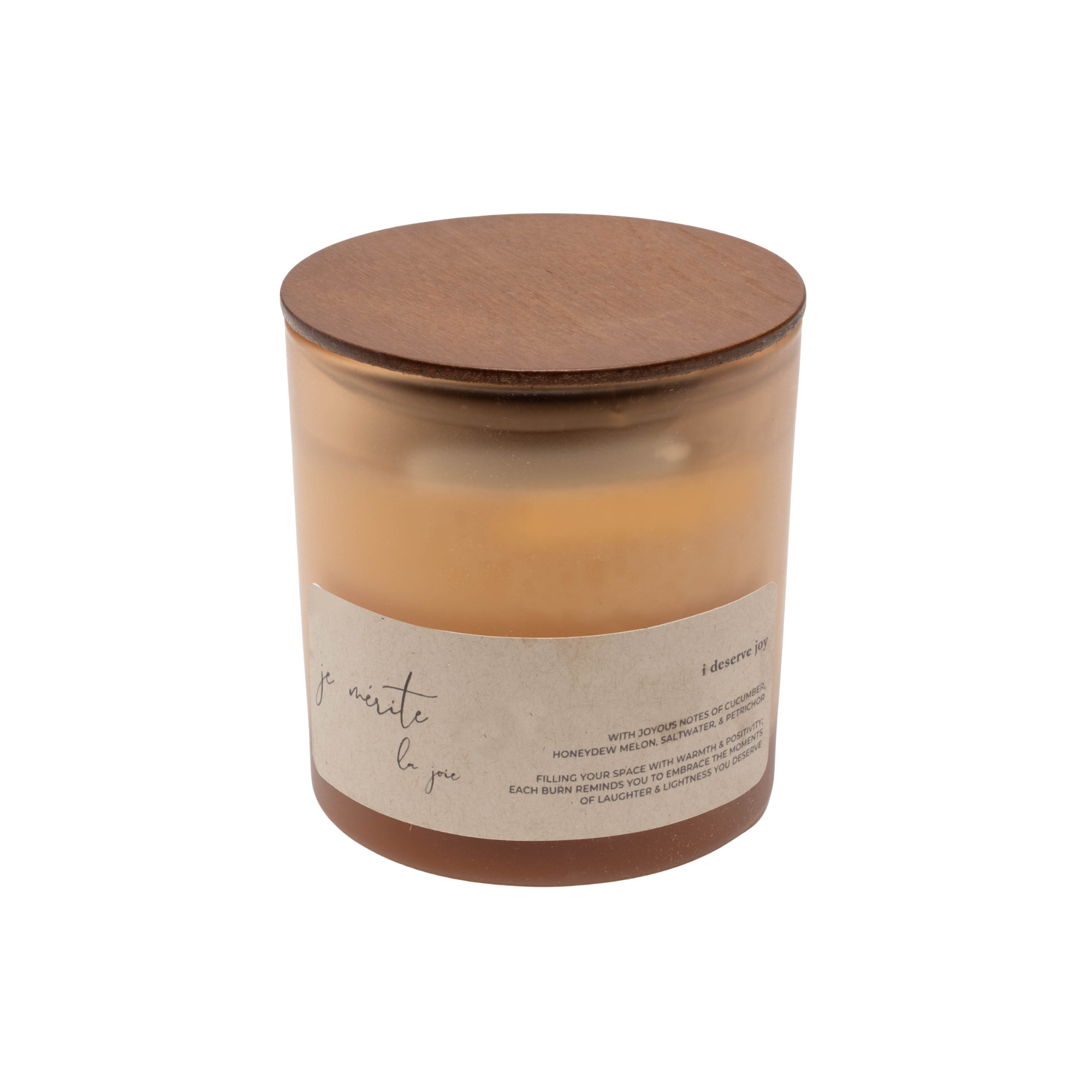 A candle in a frosted amber glass jar with a natural wood lid and a beige paper label, shown on a plain white background.
