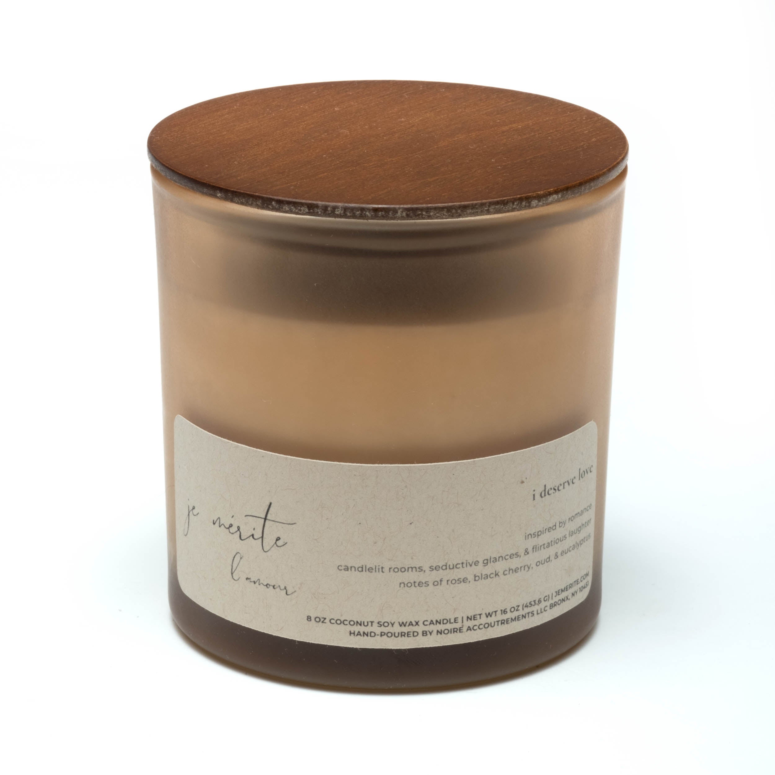 A monochrome image of a candle tin with a design that resembles a human face, with textures and cracks reminiscent of marble.