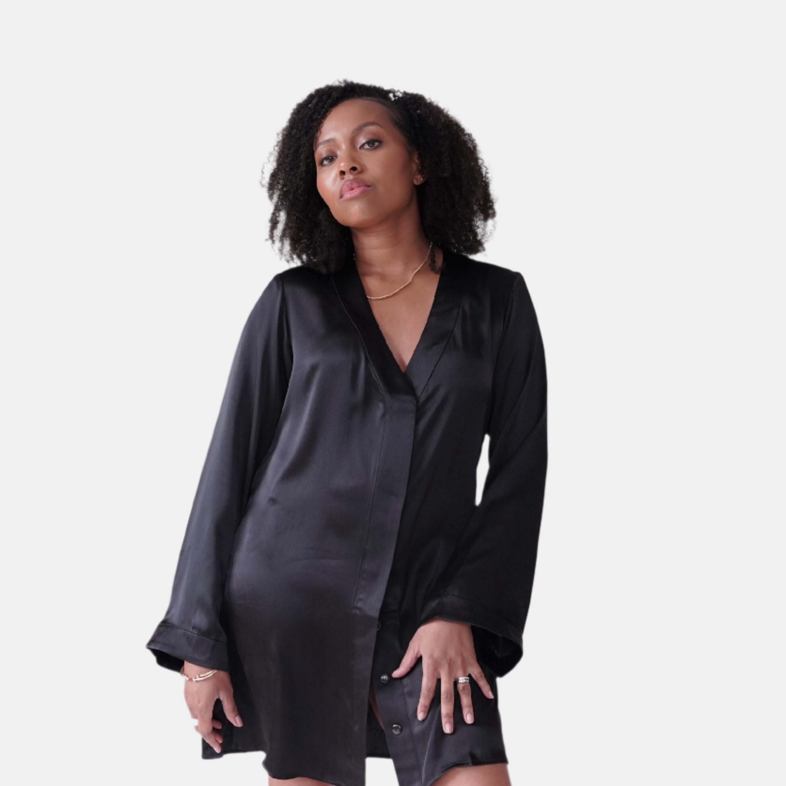 made in the softest washed silk charmeuse, this hidden button front shirt dress can be worn as a robe, pajama top or shirtdress, in and outside of the boudoir  belt loop is subtly and discretely hidden behind the back placket  complete with resting pockets  wear with a je mérite coordinating bottom or chemise  soft collar v-neck neckline subtle slits at sides removable belt sensual fit mini length  washed 100% silk charmeuse  designed and made in new york city, new york - available in 0/2-20/22
