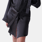 made in the softest washed silk charmeuse, this hidden button front shirt dress can be worn as a robe, pajama top or shirtdress, in and outside of the boudoir  belt loop is subtly and discretely hidden behind the back placket  complete with resting pockets  wear with a je mérite coordinating bottom or chemise  soft collar v-neck neckline subtle slits at sides removable belt sensual fit mini length  washed 100% silk charmeuse  designed and made in new york city, new york - available in 0/2-20/22