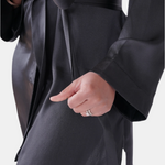 made in the softest washed silk charmeuse, this hidden button front shirt dress can be worn as a robe, pajama top or shirtdress, in and outside of the boudoir  belt loop is subtly and discretely hidden behind the back placket  complete with resting pockets  wear with a je mérite coordinating bottom or chemise  soft collar v-neck neckline subtle slits at sides removable belt sensual fit mini length  washed 100% silk charmeuse  designed and made in new york city, new york - available in 0/2-20/22