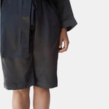 A close-up of a person wearing black silk drawstring tuxedo bermuda shorts

made in the softest washed silk charmeuse, this bermuda short has an elastic waistband and drawstring closure  wear with a je mérite coordinating top or your favorite lingerie  wide elastic waist with drawstring closure sits at natural waist  sensual fit  washed 100% silk charmeuse  designed and made in new york city, new york - available in 0/2-20/22
