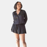 made in the softest washed silk charmeuse, this hidden button front cropped sleep shirt can be worn as a pajama top or shirt, in and outside of the boudoir wear with a je mérite coordinating bottom  soft collar v-neck neckline subtle slits at sides cropped just below the belly button  washed 100% silk charmeuse  designed and made in new york city, new york - available in 0/2-20/22