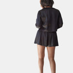 made in the softest washed silk charmeuse, this hidden button front cropped sleep shirt can be worn as a pajama top or shirt, in and outside of the boudoir wear with a je mérite coordinating bottom  soft collar v-neck neckline subtle slits at sides cropped just below the belly button  washed 100% silk charmeuse  designed and made in new york city, new york - available in 0/2-20/22