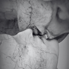 Close-up of a marble sculpture of a face with detailed texture.